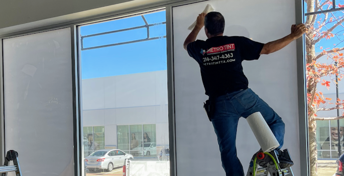 Image of Metro Tint Professional Installing a window film